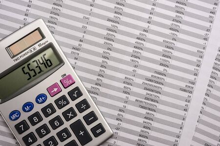 Close up shot of a calculator on top of sheets with numbersの写真素材