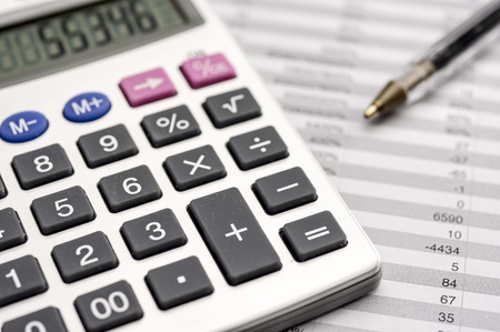 Close up shot of a calculator on top of sheets with numbersの写真素材