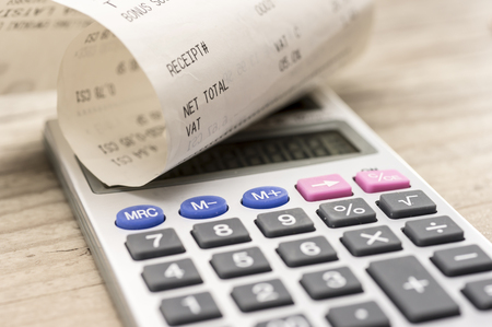 Close up shot of calculator and shopping receiptの写真素材