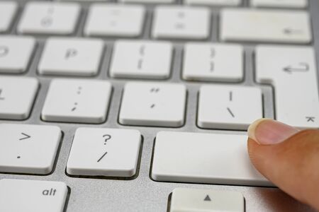 Finger pressing the shift key on keyboardの写真素材
