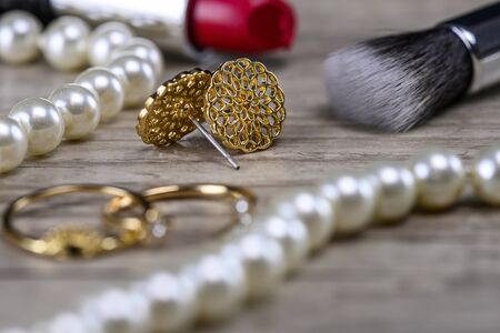 Make up, golden jewellery and pearls close upの写真素材
