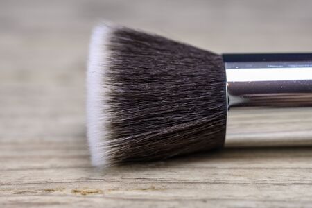 Make up powder brush on wooden tableの写真素材