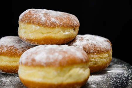 Chocolate or jelly filled donuts sprinkled with powder sugarの写真素材