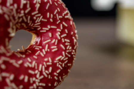Delicious pink donut with white sprinkles on table.の写真素材