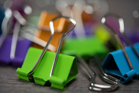 Bunch of multicolored binder clips on tableの写真素材