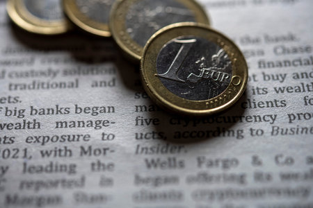 Euro coins on newspaper close up shot