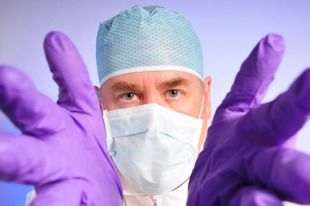 Medial person reacing in with rubber glovesの写真素材