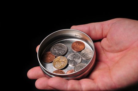 a coin in hand in todays troubled economic timesの写真素材