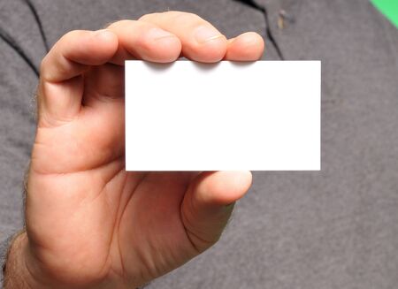 man holding a blank business cardの写真素材