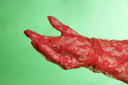 Open womans hands with red gloves against a green screenの写真素材