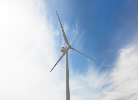 a large wind turbine for power generation in front of blue sky