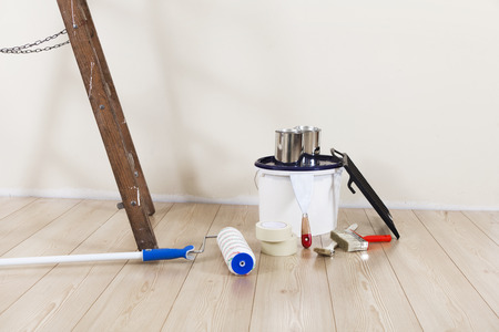 Painting supplies with ladder against a wall to be repaintedの写真素材
