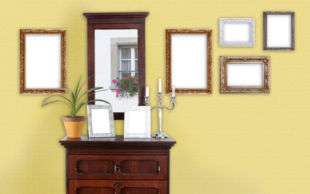 on a wall with a dresser hang several picture frames