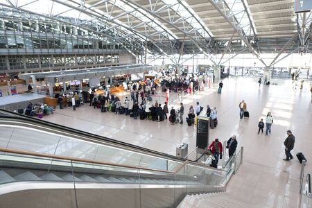Tourists with suitcases at Hamburg airport check in areaのeditorial素材