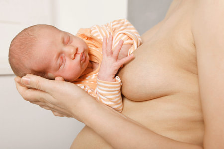 A mother holds her baby to drink from the breast