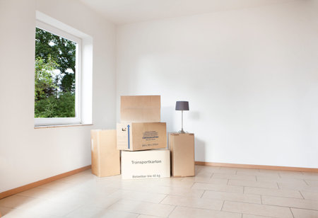 many packing boxes standing in an empty white room