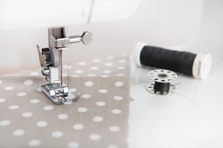 a cloth is sewn with a sewing machine, black yarn is next