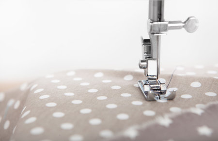 a fabric is sewn with a sewing machine, copy space