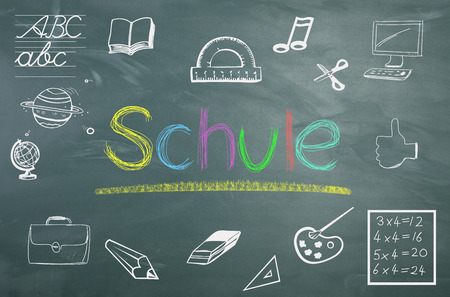 on a blackboard is the text School painted by childrenの写真素材