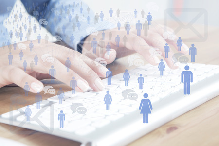 beautiful female fingers typing on a keyboard and communicate social globalの写真素材