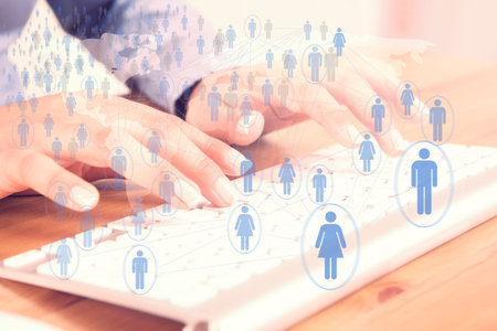 beautiful female fingers typing on a keyboard and communicate social globalの写真素材