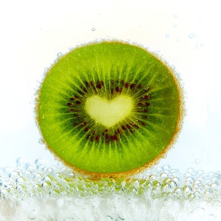 Kiwi fruit in a glass of carbonated waterの写真素材