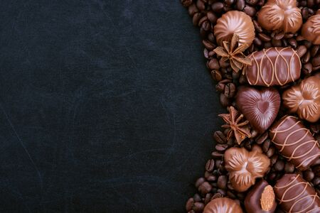 Still life of chocolate coffee beans lying on a dark backgroundの写真素材