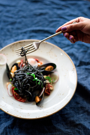 Black spaghetti beautifully served with a forkの写真素材