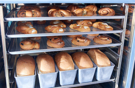 Dessert bread baking in Combi steamer. Production oven at the bakery. Baking bread. Manufacture of...