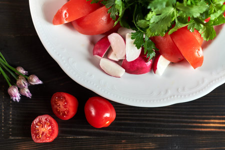 Fresh salad of tomatoes, cucumbers, peppers, arugula and dill jpgの写真素材