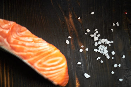 salmon fillet with yanagiba knife and solt of woodの写真素材