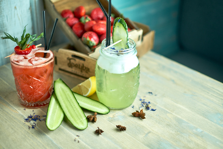 Homemade cucumber and mint lemonade in a glass on a blue wooden background. jpgの写真素材
