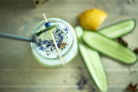 Homemade cucumber and mint lemonade in a glass on a blue wooden background. jpgの写真素材