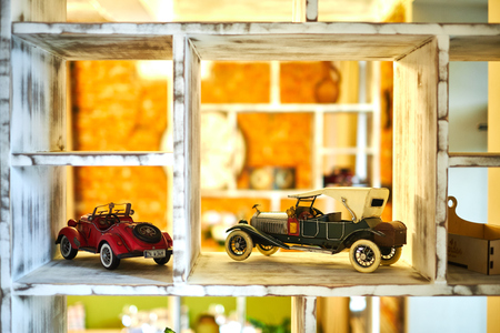Vintage car toy standing on the shelf jpgの写真素材