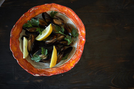 Mussels on ice ready to cook with lemon and white wine jpg