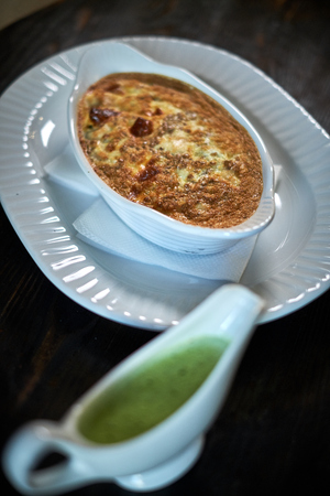 Baked trout with sauce and broccoliの写真素材