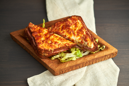 grilled sandwich on a wooden board, baked cheeseの写真素材