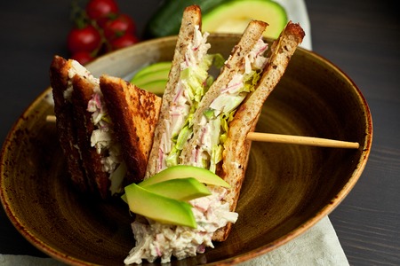 Top view of Healthy Sandwich toast with lettuce, ham, cheese and tomato on a wooden backgroundの写真素材