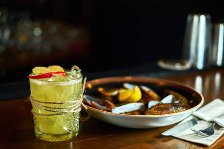 cocktail glass on the wood table in the bar. Slow motionの写真素材
