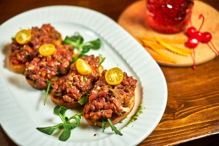 bruschetta, on slices of toasted baguette garnished with basilの写真素材