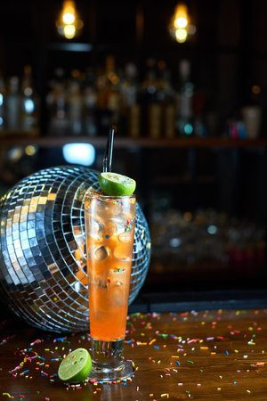cocktail glass on the wood table in the bar. Slow motion