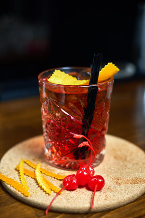 cocktail glass on the wood table in the bar. Slow motion