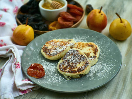 Cottage cheese casserole with sour cream on white plate. Cottage cheese baked pudding peachの写真素材