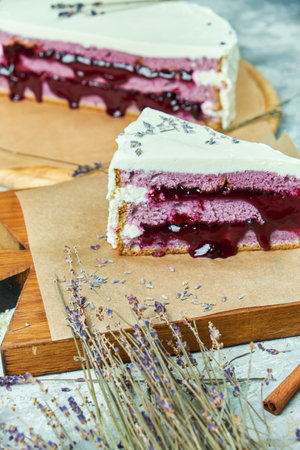 Lavender cake on a wooden board with parchment paper