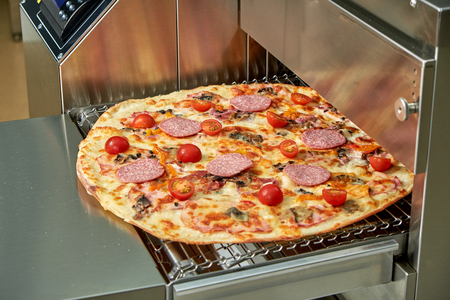 Industrial electric pizza oven for catering. Professional kitchen equipmentの写真素材