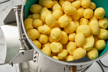 Machine for peeling potatoes on an industrialの写真素材