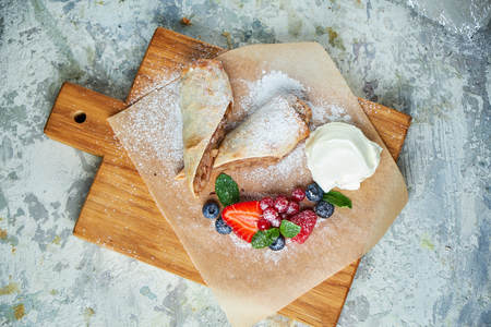 Apple strudel. Gray textured background. Beautiful serving dishes. Dessert. Food chainの写真素材