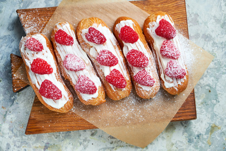 Cake eclair. Gray textured background. Beautiful serving dishes. Dessert. Food chainの写真素材