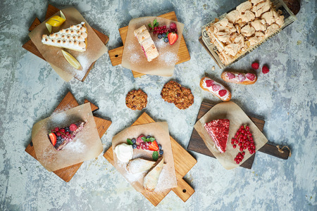 Assorted sweet desserts. Top view. Gray textured background. Beautiful serving dishes. Dessert. Food chainの写真素材