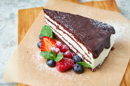 Chocolate cake. Gray textured background. Beautiful serving dishes. Dessert. Food chain